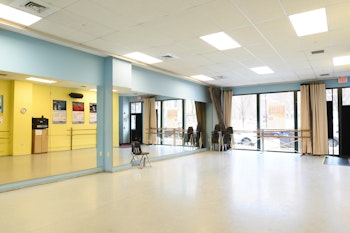 Interior photo of Chase Studio with mirrors and large street windows showing.